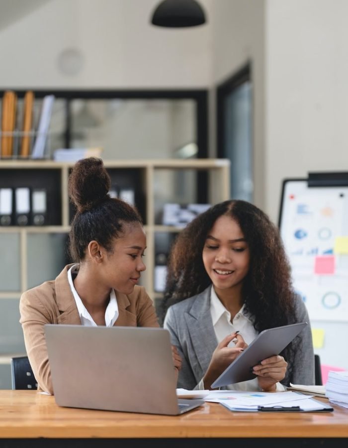 two-young-business-people-working-together-in-office-financial-analysis-accounting-concept-.jpg